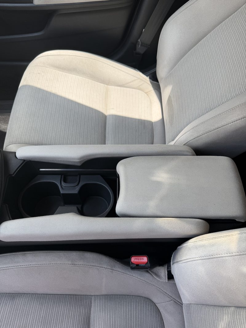 The same front seats and console after hot water extraction, clean and evenly coloured